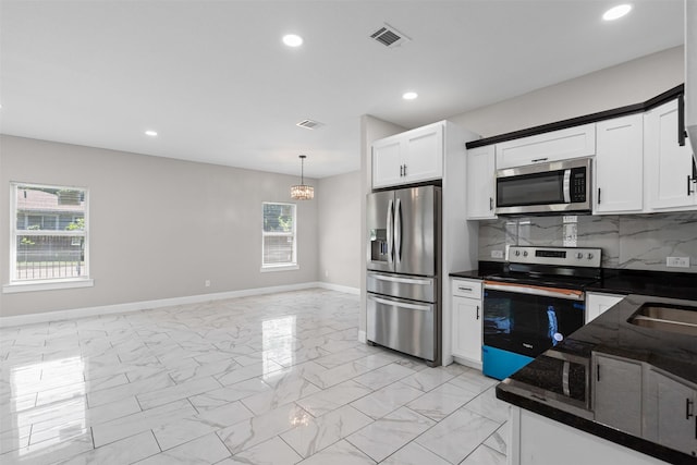 2636 Carter Ave, Fort Worth, TX 76103 - kitchen featuring appliances with stainless steel finishes, baseboards, healthy amount of natural light, light marble finish floors, and recessed lighting