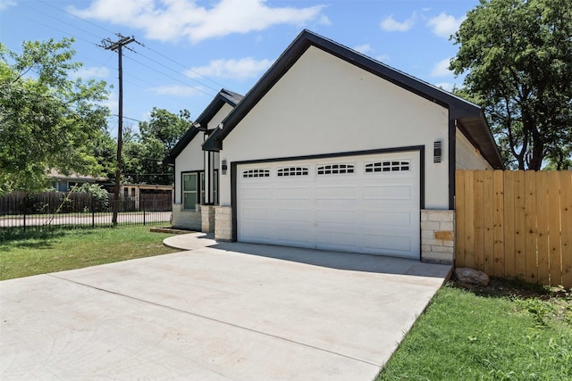 2636 Carter Ave, Fort Worth, TX 76103 - view of front of home featuring stone siding, concrete driveway, and stucco siding