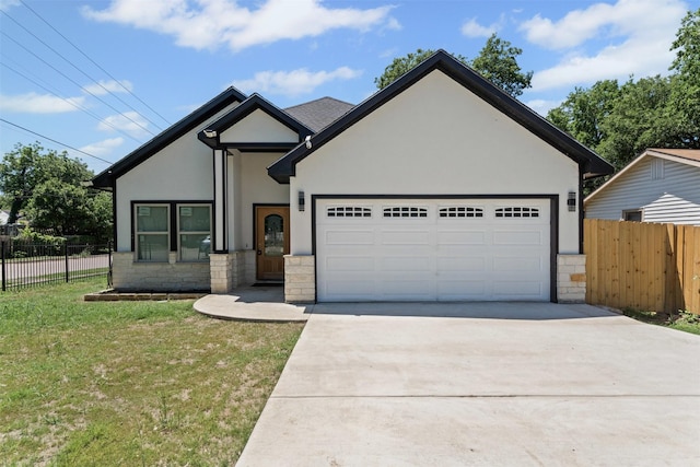 2636 Carter Ave, Fort Worth, TX 76103 - view of front of house with stone siding, concrete driveway, stucco siding, and an attached garage