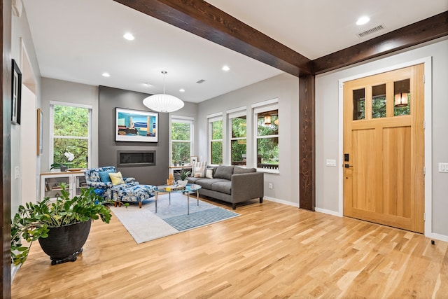 entrance foyer featuring light wood-type flooring, recessed lighting, baseboards, and beamed ceiling