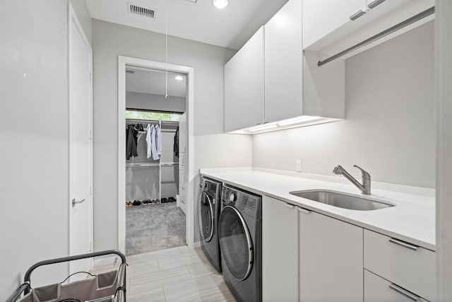 laundry room featuring washer and dryer, cabinet space, and recessed lighting