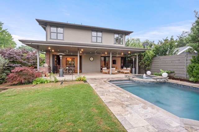 rear view of house featuring a patio area, outdoor lounge area, a ceiling fan, and a pool with connected hot tub