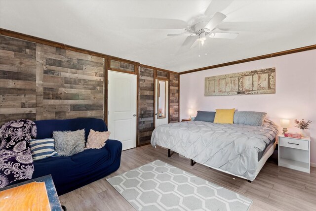 7928 Farm Rd Unit 127, Mount Pleasant, TX 75455 - bedroom with wood walls, ornamental molding, wood finished floors, baseboards, and a ceiling fan