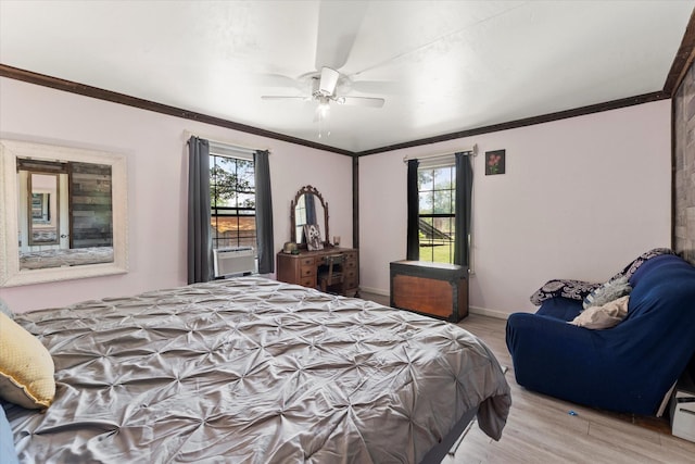 7928 Farm Rd Unit 127, Mount Pleasant, TX 75455 - bedroom featuring light wood finished floors, multiple windows, ornamental molding, ceiling fan, and baseboards