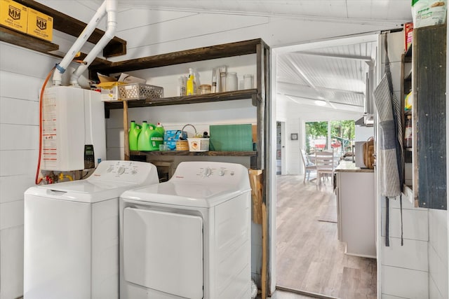 7928 Farm Rd Unit 127, Mount Pleasant, TX 75455 - washroom featuring washer and dryer, wood finished floors, and tankless water heater