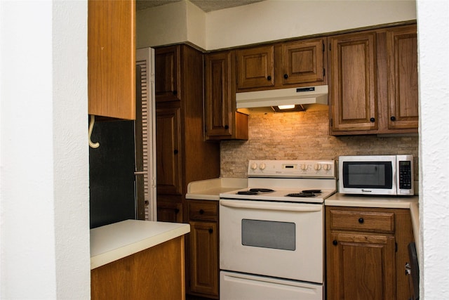 1101 Quail Valley Ln Unit 211, Arlington, TX 76011 - kitchen with white electric range oven, under cabinet range hood, stainless steel microwave, light countertops, and backsplash