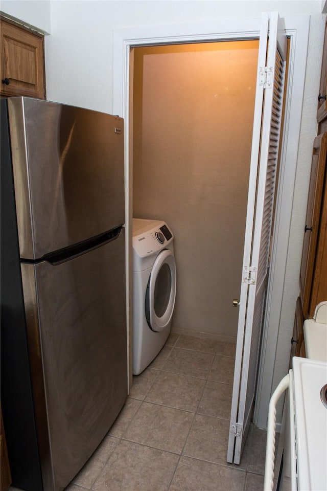 1101 Quail Valley Ln Unit 211, Arlington, TX 76011 - clothes washing area featuring washer / clothes dryer and light tile patterned floors