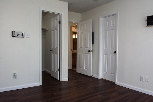 1101 Quail Valley Ln Unit 211, Arlington, TX 76011 - unfurnished bedroom with dark wood-style floors, baseboards, and ensuite bathroom