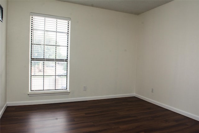 1101 Quail Valley Ln Unit 211, Arlington, TX 76011 - spare room with healthy amount of natural light, dark wood finished floors, and baseboards