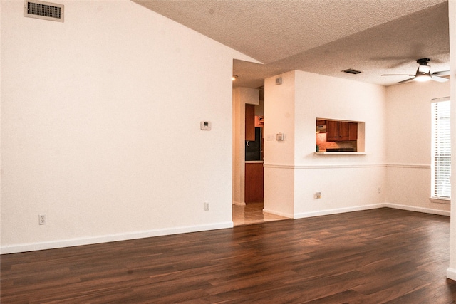 1101 Quail Valley Ln Unit 211, Arlington, TX 76011 - spare room with a textured ceiling, a ceiling fan, dark wood finished floors, and baseboards