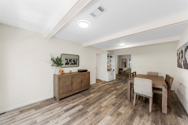 2935 Maydelle Ln, Farmers Branch, TX 75234 - dining space featuring beamed ceiling, wood finished floors, and baseboards