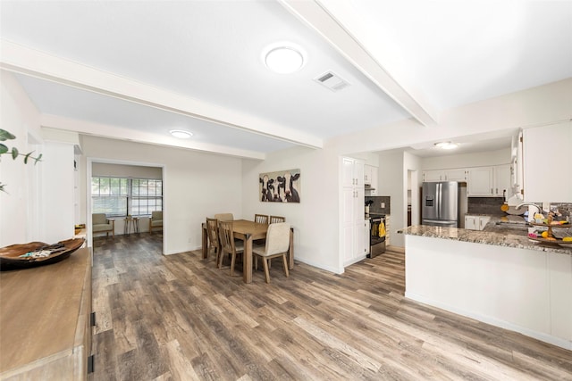 2935 Maydelle Ln, Farmers Branch, TX 75234 - kitchen with stainless steel fridge, a sink, beam ceiling, wood finished floors, and white cabinetry