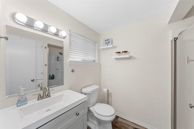 2935 Maydelle Ln, Farmers Branch, TX 75234 - bathroom featuring toilet, a shower stall, baseboards, vanity, and wood finished floors