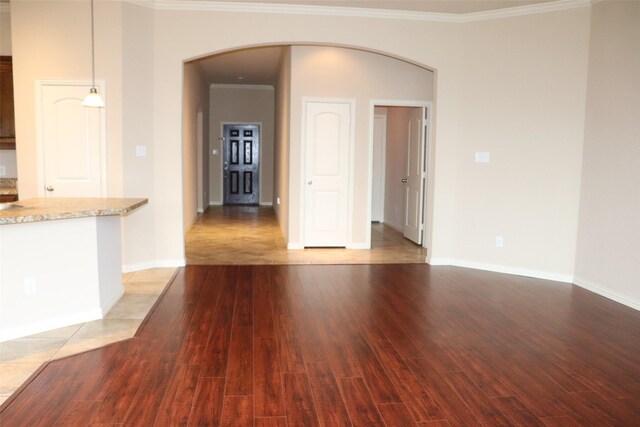 414 Stonecreek Dr, Princeton, TX 75407 - unfurnished living room featuring arched walkways, ornamental molding, light wood-type flooring, and baseboards