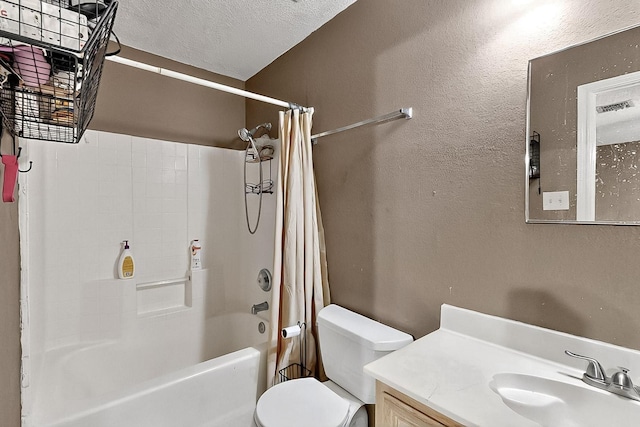 bathroom featuring toilet, shower / tub combo, vanity, and a textured ceiling