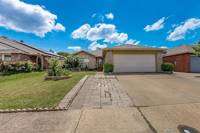 ranch-style house featuring an attached garage, concrete driveway, a front lawn, and brick siding