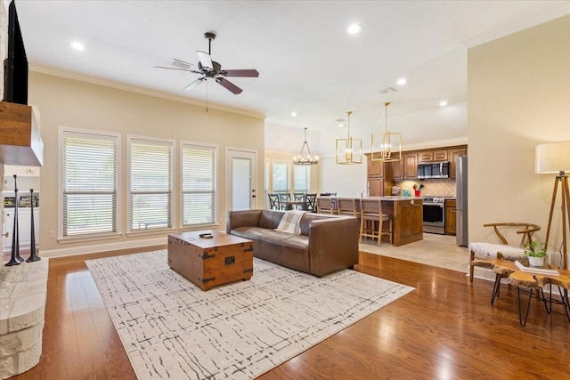 213 Desert Sky Dr, Mcgregor, TX 76657 - living area with ceiling fan, light wood-style flooring, ornamental molding, recessed lighting, and a chandelier