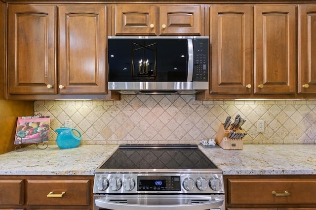 213 Desert Sky Dr, Mcgregor, TX 76657 - kitchen featuring stainless steel appliances, light stone countertops, and decorative backsplash