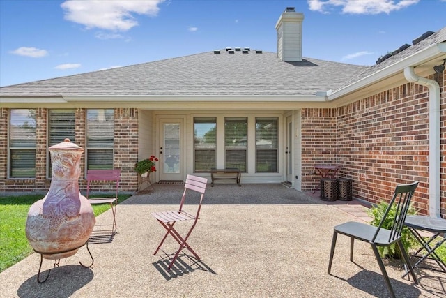 213 Desert Sky Dr, Mcgregor, TX 76657 - rear view of property featuring brick siding, a patio area, roof with shingles, and a chimney