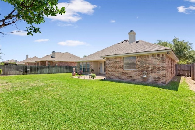 213 Desert Sky Dr, Mcgregor, TX 76657 - rear view of house with brick siding, a patio, roof with shingles, and a chimney
