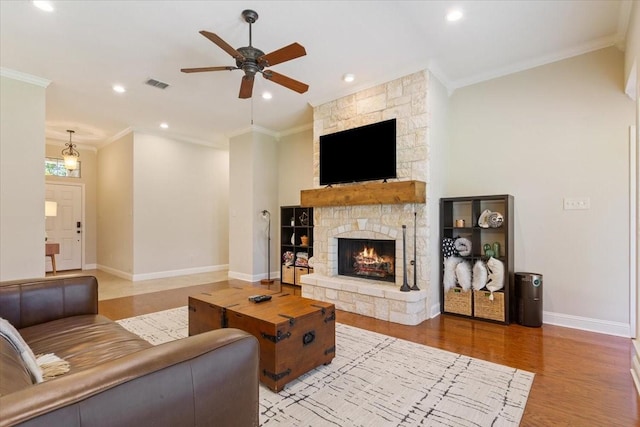213 Desert Sky Dr, Mcgregor, TX 76657 - living area featuring a ceiling fan, ornamental molding, a fireplace, baseboards, and wood finished floors