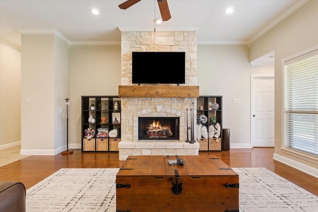 213 Desert Sky Dr, Mcgregor, TX 76657 - living area featuring ceiling fan, a stone fireplace, crown molding, wood finished floors, and baseboards