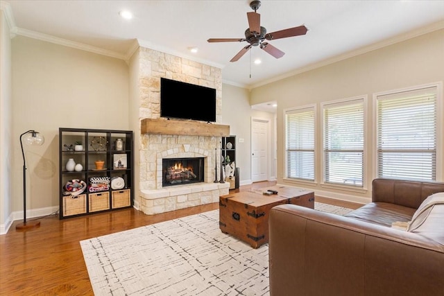 213 Desert Sky Dr, Mcgregor, TX 76657 - living area featuring ornamental molding, a fireplace, wood finished floors, a ceiling fan, and baseboards