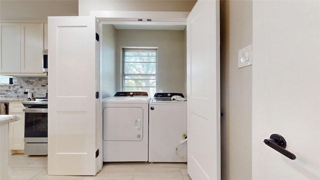1408 Briarwood Blvd, Arlington, TX 76013 - laundry area featuring washing machine and dryer and light tile patterned floors