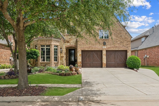 8917 Cypress Creek Rd, Lantana, TX 76226 - view of front of house with brick siding, a garage, concrete driveway, and a front lawn