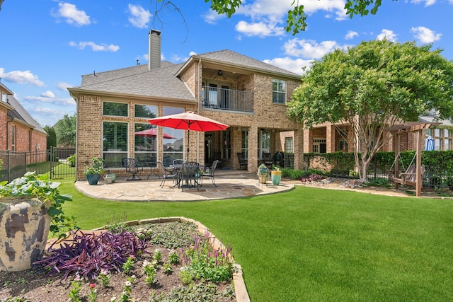 8917 Cypress Creek Rd, Lantana, TX 76226 - back of property featuring a balcony, brick siding, a chimney, a ceiling fan, and a patio area