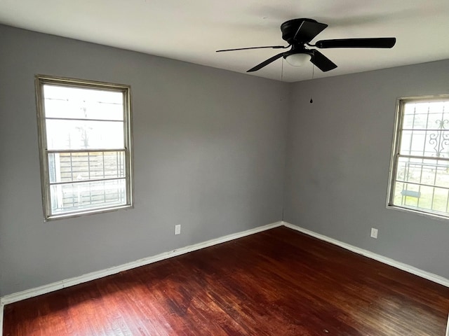 2836 Modree Ave, Dallas, TX 75216 - spare room featuring dark wood finished floors, baseboards, and ceiling fan