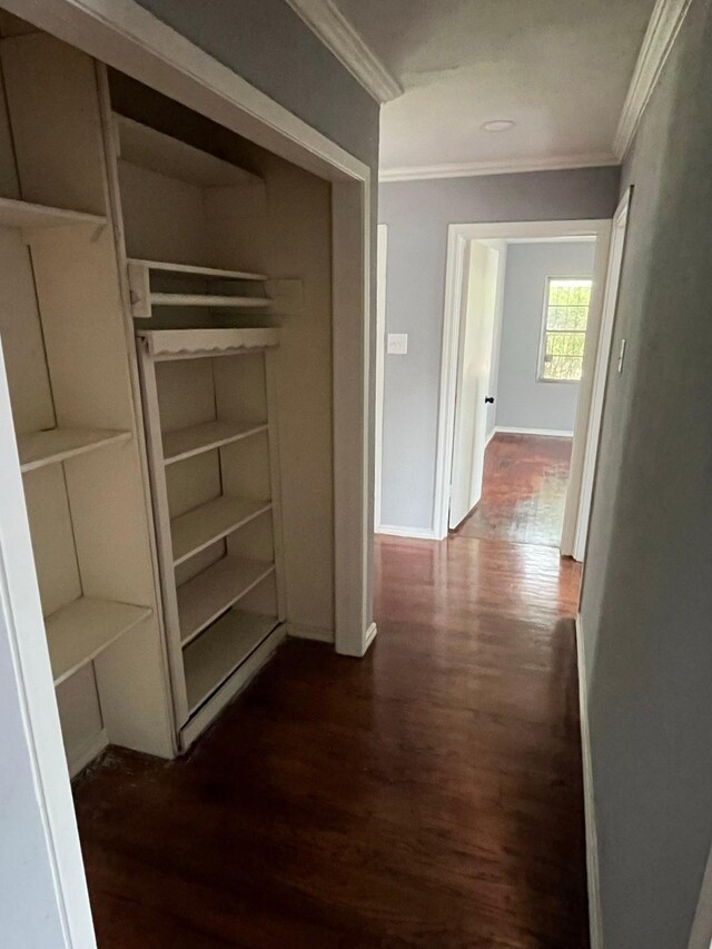 2836 Modree Ave, Dallas, TX 75216 - hallway featuring crown molding, dark wood-type flooring, and baseboards