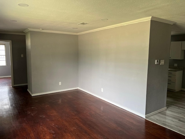 2836 Modree Ave, Dallas, TX 75216 - spare room featuring wood finished floors, crown molding, baseboards, and a textured ceiling