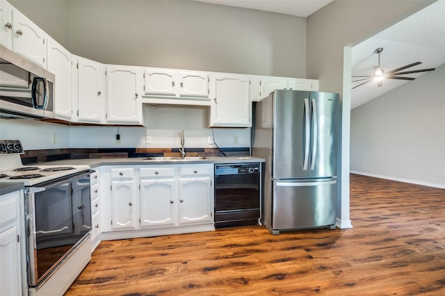2005 Parkside Dr, Denton, TX 76201 - kitchen featuring stainless steel appliances, a sink, white cabinetry, dark wood-type flooring, and lofted ceiling