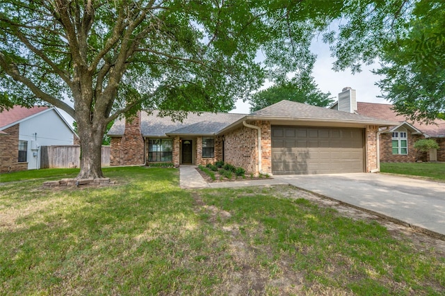 2005 Parkside Dr, Denton, TX 76201 - view of front facade featuring a garage, driveway, a front yard, brick siding, and a chimney