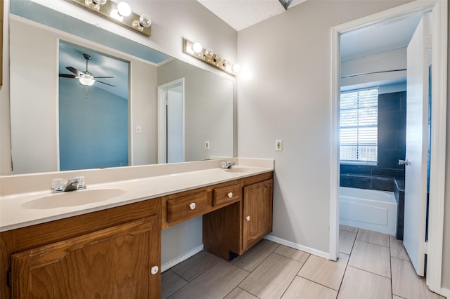 2005 Parkside Dr, Denton, TX 76201 - full bathroom with double vanity, a tub to relax in, baseboards, and ceiling fan
