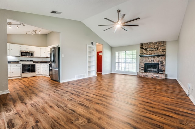 2005 Parkside Dr, Denton, TX 76201 - unfurnished living room with a ceiling fan, dark wood-style flooring, baseboards, and high vaulted ceiling