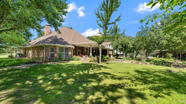 253 Valtie Davis Rd, Combine, TX 75159 - back of property featuring a lawn, brick siding, and a chimney