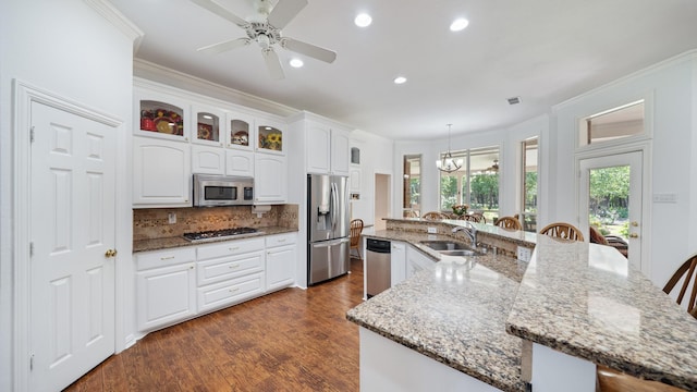 253 Valtie Davis Rd, Combine, TX 75159 - kitchen featuring stainless steel appliances, a sink, a kitchen breakfast bar, crown molding, and white cabinets