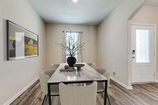 412 Lowery Oaks Trl, Fort Worth, TX 76120 - dining area featuring arched walkways, wood finished floors, healthy amount of natural light, and baseboards