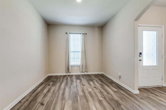 412 Lowery Oaks Trl, Fort Worth, TX 76120 - empty room featuring arched walkways, wood finished floors, and baseboards