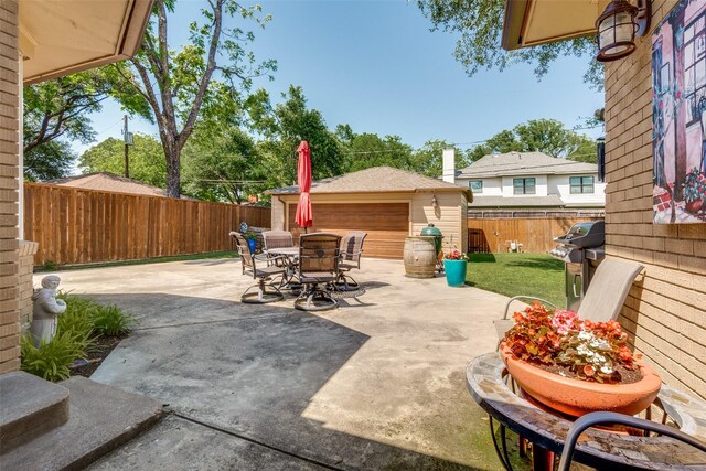 7219 Haverford Rd, Dallas, TX 75214 - view of patio / terrace featuring outdoor dining space, a fenced backyard, an outbuilding, and area for grilling