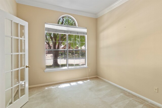 unfurnished room featuring carpet, crown molding, and baseboards