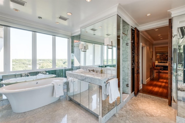 4500 Roland Ave Unit 801, Highland Park, TX 75219 - bathroom with crown molding, healthy amount of natural light, a soaking tub, marble tiled flooring, and recessed lighting