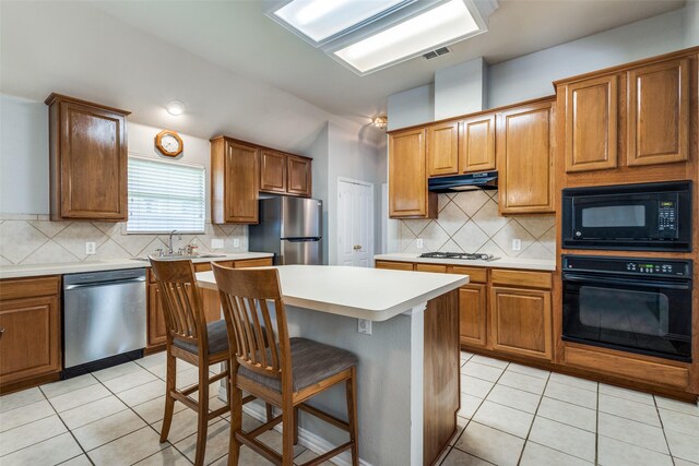 kitchen with light tile patterned floors, light countertops, open floor plan, brown cabinets, and vaulted ceiling