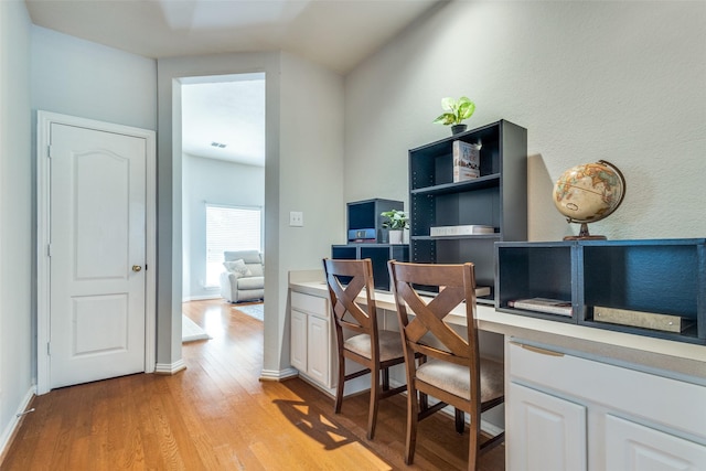 office area with light wood-type flooring and baseboards