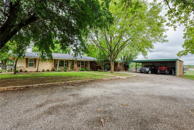 2405 Poolville Cut Off Rd, Poolville, TX 76487 - ranch-style home featuring gravel driveway, a front yard, and a carport