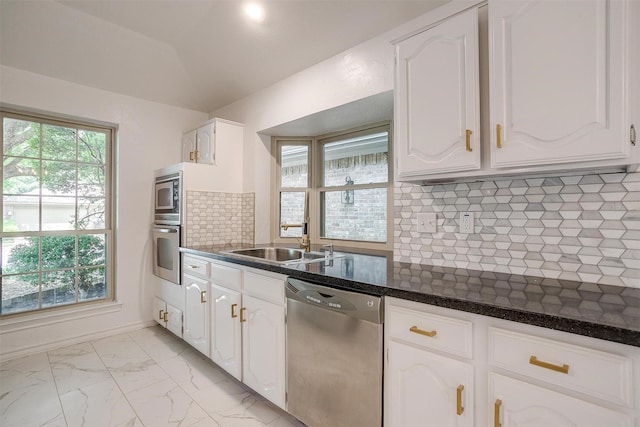 2204 Mediterranean Ave, Arlington, TX 76011 - kitchen featuring stainless steel appliances, a sink, white cabinets, tasteful backsplash, and light marble finish flooring