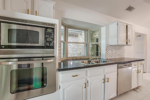 2204 Mediterranean Ave, Arlington, TX 76011 - kitchen featuring stainless steel appliances, a sink, white cabinetry, and light marble finish floors