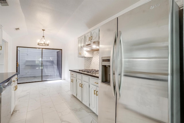 2204 Mediterranean Ave, Arlington, TX 76011 - kitchen with appliances with stainless steel finishes, dark countertops, light marble finish floors, a chandelier, and under cabinet range hood
